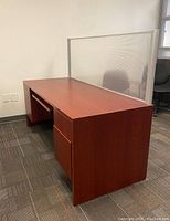 Side angle photo showing desk with drawers on one side and keyboard tray underneath desktop.