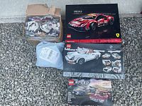 Overview of all four items: bulk bricks, sealed package, Ferrari and Porsche Technic boxes, Speed Champions box