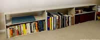 Front angle view of the bookcase with several books placed inside for scale but books are not included.