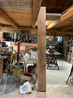 Full view of vertical beam standing in workshop showing length and thickness