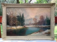 Full frontal image of the oil painting showing the cabin on river scene with frame.