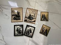 All six silhouette art pieces laid on floor showing different frame styles and sizes.