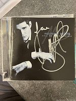 Front cover of Michael Bublé "Call Me Irresponsible" CD with signature in silver marker.