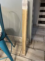 Bamboo blinds new in original packaging leaning against wall showing length and width measurement.