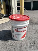 Closed bucket showing CGC Sheetrock All Purpose Lite branding and red lid