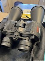 Close-up of the binoculars showing large objective lenses and textured grip with red Premium logo.