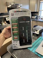 Front of the Monster Home Theater Surge Protector in original packaging showing features and image of the power bar itself.