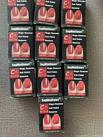 Top view showing the front of ten SegMiniSmart Magic Nail Polish Remover boxes arranged in two rows on a carpeted floor.