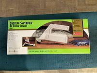 Top view of original packaging showing the vacuum unit image and product details.