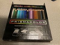 Black Prismacolor box containing 48 assorted colored pencils arranged in rows, showing the colors and the box label clearly.