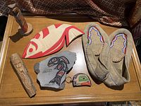 Overall view of all five First Nations items on a wooden table