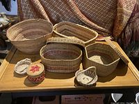 Overview of all seven baskets on tabletop, showing relative sizes and shapes