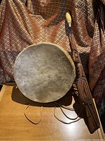 Full view of drum and drumstick displaying overall size and design