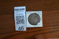 Top-down photo of a Portuguese silver coin from 1816, denomination 400 Reis, in a cardboard holder with handwritten notes.