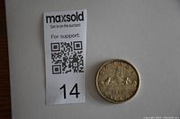 Photo of the reverse side of the 1957 Canadian silver dollar coin with the Voyageur design and 'CANADA DOLLAR' text.