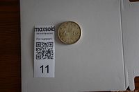 Full view of 1962 Canadian silver dollar coin on white background with size reference card.