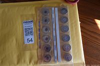 Two strips of coins in plastic holders displaying a selection of Canadian commemorative coins.