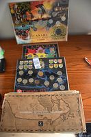 Full view of three Canadian coin collector sets from different years including Canada 125, 1994 commemorative, and Millennium sets.