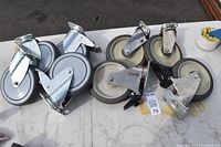 Group of 8 casters with metal mounting plates and 5-1/2 inch wheels, some with brakes