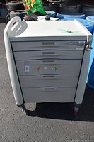 Front view of cart showing overall condition, drawer layout, integrated handle and caster wheels