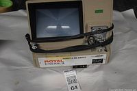 Photo showing the full front and side view of the beige Royal E-700 Dual 8 movie projector and viewer unit with screen, power cord, and controls visible.