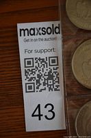 Photo of MaxSold auction label with lot number 43 on wooden surface.