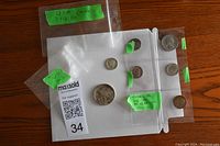 Photo of all coins displayed, including 1942 half dollar, 1916 worn dime, three 1960s dimes, and 1939 penny