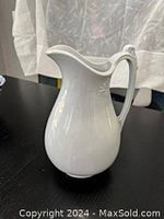 Full view of white ironstone pitcher showing classical shape and glossy finish