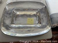 Top view of the large rectangular metal serving platter showing its shape and surface condition.