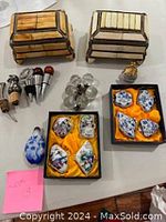 Overview photo showing all items: two Moroccan boxes, snuff bottle, bar bottle stoppers, decorative pill boxes, and crystal drawer knobs.