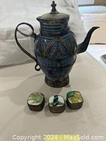 Vintage Moroccan metal wrapped ceramic pot and three small square metal pill boxes with hand-painted tile tops featuring nature and abstract motifs