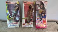 Three boxed Spice Girls dolls in a row: two Scary Spice and one Sporty Spice with music feature.