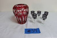 Photo of ruby crystal vase and five vintage ruby red cut-to-clear shot glasses together