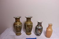 Four vases displayed in a row showing size and design differences