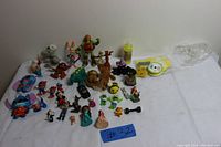 Full overview of the lot showing all toys arranged on a white sheet.