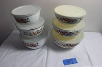 Two sets of vintage Kobe floral metal nesting mixing bowls, each with three bowls and fitted lids, showing floral designs and bowl dimensions.