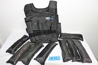Front view of Run Max weighted vest with eight removable weight packets laid out in front