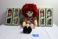 Photo showing all four Sarah's Gang Collectors Club dolls in their original green boxes along with the Raggedy Ann cloth doll sitting in front.