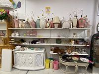 Wide view of IKEA retail shelving units with lamps and glassware displayed on shelves.