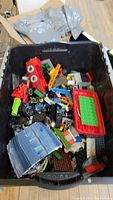 Large tote containing assorted Lego and Lego Friends bricks, vehicle parts, and accessories