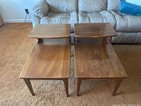Pair of solid wood mid-century end tables showing top and side views with visible wood grain and two-tier design.