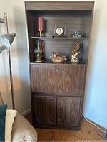 Full view of shelf unit with decorative items on shelves to show size and open shelving