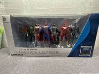 Front view of the sealed 7-pack featuring all Justice League figures