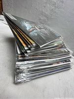 Stack of comic books in protective sleeves showing art covers with Lara Croft.