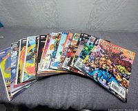 Lot of 18 Fantastic Four comic books shown spread out on fabric surface, covers visible showing various characters and action scenes.