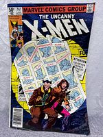 Front cover showing Wolverine and Kitty Pryde with wanted posters of X-Men characters in the background, labeled as slain or apprehended.