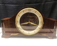 Front view of the wooden mantel clock showing dial and casing
