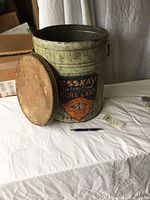 Large vintage Esskay Pure Lard can on white cloth background, wooden lid removed and placed next to it, showing size and detail of the can.