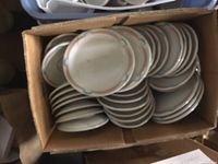 Top-down view of stacked luncheon plates showing the white base with pink and blue decorative edges.