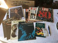 Overview of all items showing magazines, sheet music, and cookbook arranged on a surface